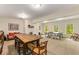 Spacious game room with ping pong table, casual seating, large wooden table, and a view of the backyard at 130 River Ne Lndg, Sandy Springs, GA 30350