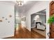 Inviting hallway featuring hardwood floors, a modern light fixture, and seamless access to a cozy living room at 130 River Ne Lndg, Sandy Springs, GA 30350