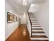 Hallway with hardwood floors, staircase, decorative lighting, and access to the front door at 130 River Ne Lndg, Sandy Springs, GA 30350