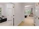 Bright hallway leading to a sunroom with luxury massage chair and an adjacent bathroom at 130 River Ne Lndg, Sandy Springs, GA 30350