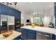 Bright kitchen with a large island, blue cabinets, and modern appliances, perfect for entertaining and everyday use at 130 River Ne Lndg, Sandy Springs, GA 30350