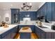 Charming kitchen featuring custom blue cabinetry, white countertops, and modern appliances at 130 River Ne Lndg, Sandy Springs, GA 30350