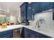 Beautiful kitchen featuring custom blue cabinets, white countertops, stainless steel appliances and decorative tile backsplash at 130 River Ne Lndg, Sandy Springs, GA 30350