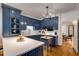 Elegant kitchen with blue cabinets, a white countertop, and a charming chandelier, ideal for culinary enthusiasts at 130 River Ne Lndg, Sandy Springs, GA 30350