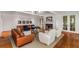 Elegant living room with a fireplace, hardwood floors, stylish seating and abundant natural light at 130 River Ne Lndg, Sandy Springs, GA 30350