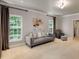 Bright, carpeted living room with neutral walls, large windows, comfortable seating, and stylish décor at 130 River Ne Lndg, Sandy Springs, GA 30350