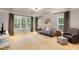 Bright, carpeted living room with neutral walls, large windows, comfortable seating, and stylish décor at 130 River Ne Lndg, Sandy Springs, GA 30350