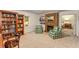 Comfortable living room featuring built-in bookshelves, a brick fireplace, plush seating, and carpeted floors at 130 River Ne Lndg, Sandy Springs, GA 30350