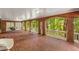 Covered patio with brick flooring, seating, and view of the wooded yard at 130 River Ne Lndg, Sandy Springs, GA 30350