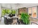 Relaxing screened porch with a stone fireplace, ceiling fans, stylish furniture, and serene wooded views at 130 River Ne Lndg, Sandy Springs, GA 30350