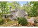 Rear exterior featuring screened in porch and attached two-car garage at 130 River Ne Lndg, Sandy Springs, GA 30350
