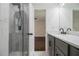 Bathroom featuring a walk-in shower, gray vanity, and marble countertop at 1926 Lakewood Se Ter, Atlanta, GA 30315