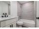 Bathroom featuring a shower-tub combo with gray tile and a white vanity at 1926 Lakewood Se Ter, Atlanta, GA 30315