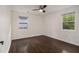 Bedroom featuring hardwood floors, a ceiling fan, and two windows at 1926 Lakewood Se Ter, Atlanta, GA 30315