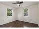 Bedroom featuring hardwood floors, a ceiling fan, and two windows at 1926 Lakewood Se Ter, Atlanta, GA 30315