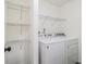 Bright laundry room featuring a white washer and dryer with wire shelving at 1926 Lakewood Se Ter, Atlanta, GA 30315