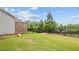 Large grassy backyard with a privacy fence and mature trees, ideal for outdoor activities at 4591 Grenadine Cir, Acworth, GA 30101