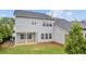 Back of home boasts a well-maintained yard, patio, and views from the upper and lower windows at 4591 Grenadine Cir, Acworth, GA 30101
