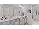 Bright bathroom featuring double vanity, sleek marble countertops, and ample storage space at 4591 Grenadine Cir, Acworth, GA 30101