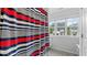 Bathroom with striped curtains and a window overlooking the neighborhood at 4591 Grenadine Cir, Acworth, GA 30101