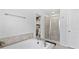 Bathroom with a soaking tub, separate shower with glass door, and walk-in closet with custom shelving at 4591 Grenadine Cir, Acworth, GA 30101