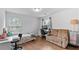 Bedroom with hardwood flooring, desk, sofa and a large window at 4591 Grenadine Cir, Acworth, GA 30101