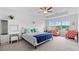 Bright bedroom featuring a tray ceiling, plush carpeting, a cozy sitting area, and serene natural views at 4591 Grenadine Cir, Acworth, GA 30101