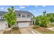 Beautifully landscaped two-story home with gray siding, brick accents, and lush green lawn at 4591 Grenadine Cir, Acworth, GA 30101