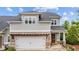 Charming two-story home with gray siding, brick accents, and a well-manicured lawn offers curb appeal at 4591 Grenadine Cir, Acworth, GA 30101