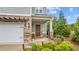 Inviting front porch with a charming entryway, brick accents, and well-maintained landscaping at 4591 Grenadine Cir, Acworth, GA 30101