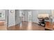 Open concept living room with hardwood floors, television, and access to other rooms at 4591 Grenadine Cir, Acworth, GA 30101