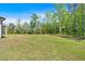 Large grassy backyard has mature trees at 4708 Cooling Water Sw Cir, Powder Springs, GA 30127