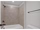 Neutral tiled shower and bathtub combo with black hardware at 4708 Cooling Water Sw Cir, Powder Springs, GA 30127