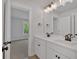 Bathroom features a double sink vanity with modern fixtures and decorative mirror lighting at 4708 Cooling Water Sw Cir, Powder Springs, GA 30127