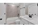 Modern bathroom features a tub and shower combination, and a sleek vanity with dark hardware at 4708 Cooling Water Sw Cir, Powder Springs, GA 30127