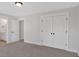 Bedroom with double doors to closets, white walls, and doorway to the en suite bathroom at 4708 Cooling Water Sw Cir, Powder Springs, GA 30127