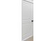 A paneled door in a neutral-toned space with dark hardware at 4708 Cooling Water Sw Cir, Powder Springs, GA 30127