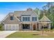 Charming new construction two-story home with a brick and gray siding, timber accents, and a manicured lawn at 4708 Cooling Water Sw Cir, Powder Springs, GA 30127
