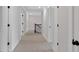 Neutral hallway with paneled doors and carpeted flooring at 4708 Cooling Water Sw Cir, Powder Springs, GA 30127