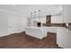 Modern kitchen with a large island, white cabinets, stainless appliances, and hardwood floors at 4708 Cooling Water Sw Cir, Powder Springs, GA 30127
