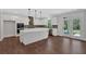 Spacious kitchen with white cabinets, island, stainless steel appliances and access to a patio at 4708 Cooling Water Sw Cir, Powder Springs, GA 30127