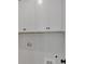 New laundry room with washer and dryer hookups and white storage cabinets at 4708 Cooling Water Sw Cir, Powder Springs, GA 30127