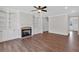 Bright living room features hardwood floors, built-in shelving, cabinets, fireplace, and open floor plan at 4708 Cooling Water Sw Cir, Powder Springs, GA 30127
