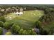 Scenic aerial view of the golf course and putting range with mature trees and lush landscaping at 670 Trinity Pl, Suwanee, GA 30024