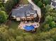 Aerial view of the property highlighting the manicured landscaping, pool with hot tub, and outdoor living spaces at 670 Trinity Pl, Suwanee, GA 30024