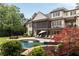 Gorgeous backyard boasts a swimming pool, patio, and lush landscaping for ultimate relaxation at 670 Trinity Pl, Suwanee, GA 30024