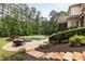 Expansive backyard featuring a pool, spa, and outdoor dining area, perfect for entertaining and relaxation at 670 Trinity Pl, Suwanee, GA 30024