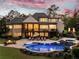 Luxurious backyard with a sparkling pool, spa, fire pit, and outdoor lounge area, perfect for entertaining at 670 Trinity Pl, Suwanee, GA 30024