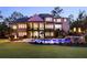Rear exterior view of a house with a screened-in porch overlooking the pool, hot tub, and fire pit at 670 Trinity Pl, Suwanee, GA 30024