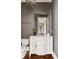 Elegant bathroom featuring ornate white vanity, framed mirror, and hardwood floors at 670 Trinity Pl, Suwanee, GA 30024